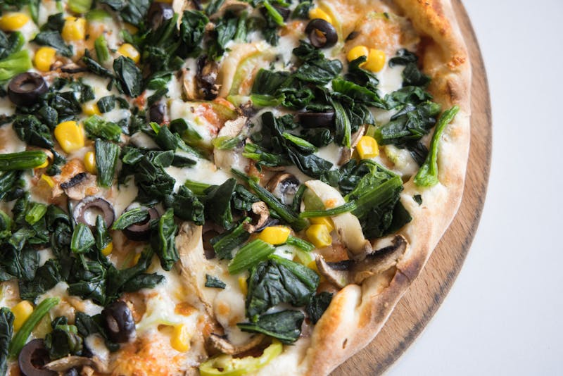 Veggie supreme pizza topped with colorful fresh vegetables