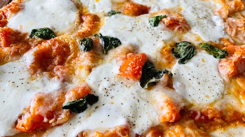 Classic Margherita pizza with fresh basil and mozzarella